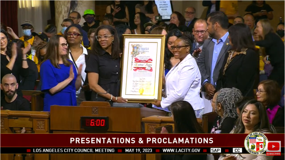 A Group Of People Stands Together At A Los Angeles City Council Meeting, Holding A Framed Proclamation. The Screen Reads PRESENTATIONS & PROCLAMATIONS With The Date May 19, 2023, At The Bottom. A Group Of People Stands Together At A Los Angeles City Council Meeting, Holding A Framed Proclamation. The Screen Reads PRESENTATIONS & PROCLAMATIONS With The Date May 19, 2023, At The Bottom.