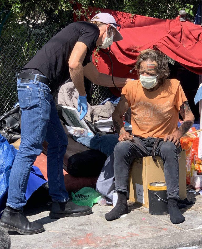 Dr._Coley_M._King_with_patient_on_the_streets-768×944