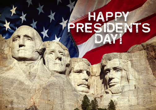 Mount Rushmore With The Faces Of Four U.S. Presidents, An American Flag In The Background, And The Words Happy Presidents Day! Written In White Text.